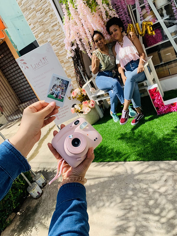 reviewer photo of the camera and a photo they took with what the photo is of in the background