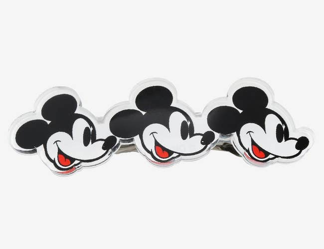 a barrette with three mickey mouse faces on it