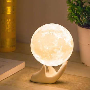 the moon light in a ceramic hand base