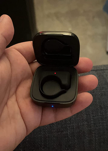 reviewer holding the tiktok remote in black