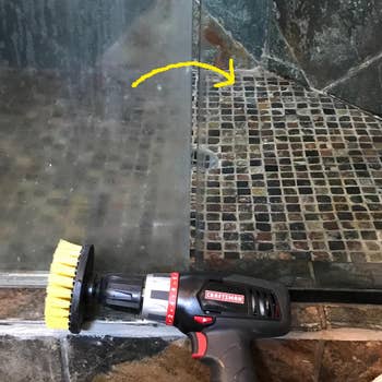 one of the brushes attached to a drill next to a shower pane with half still fogged up and the other super clear