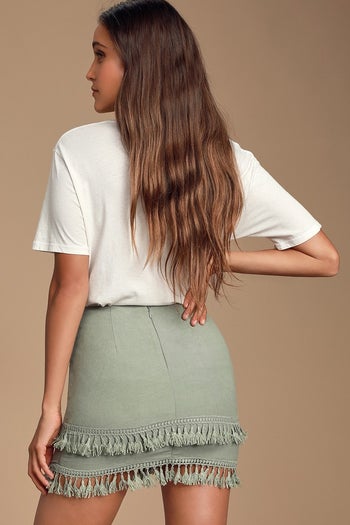 Image of model wearing green skirt