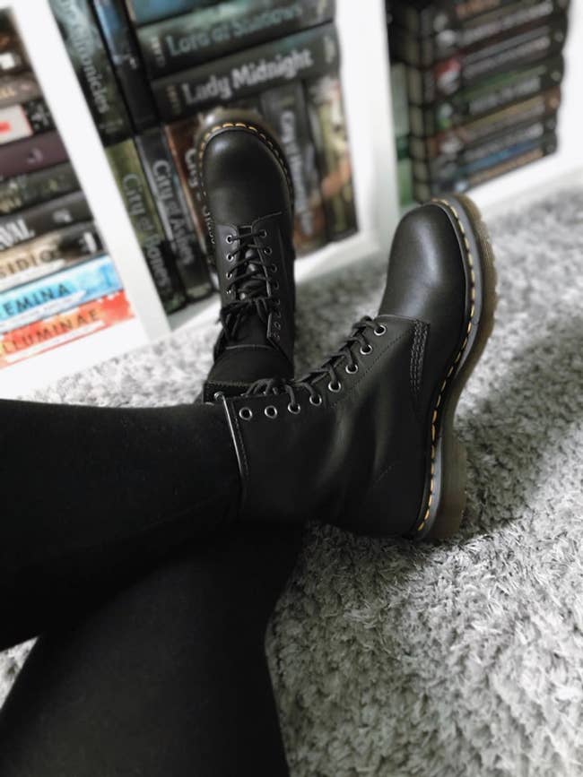 reviewer wearing black dr marten boots