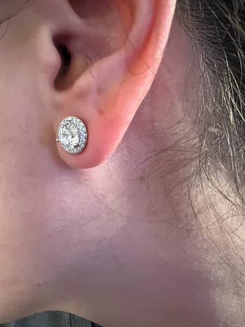 same reviewer's after photo of the earring looking nice and straight while using the lobe support patches