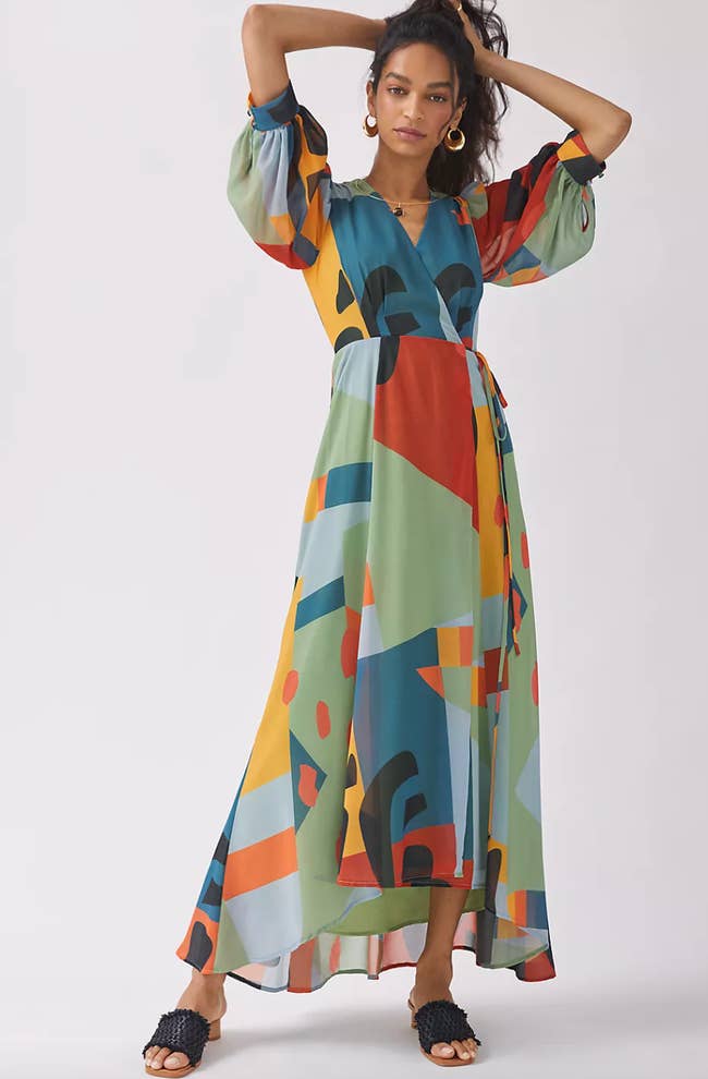 Model in geo print maxi dress with V wrap neck and elbow length balloon sleeves 