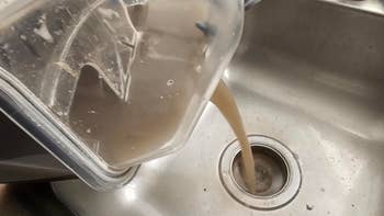 Liquid being poured from a blender into a sink, showing the cleanup process   aft  blending