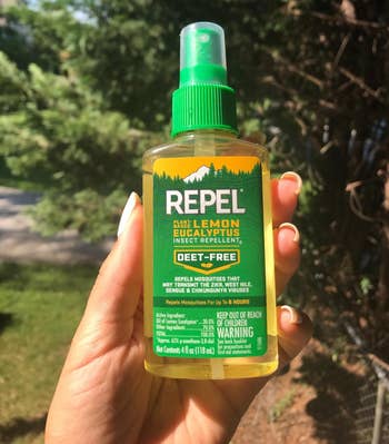 reviewer holding the bug repellant