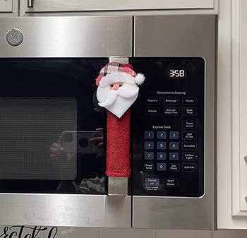 reviewer photo of the santa handle cover on the handle of a microwave