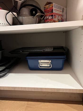 A reviewer's set of pans all combined and put away in a cabinet