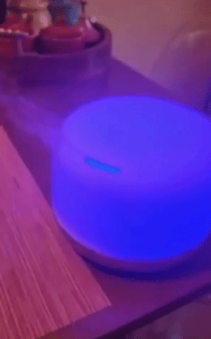 GIF of the diffuser lit up blue and emitting mist
