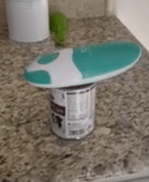 reviewer gif of the green and white can opener opening a can