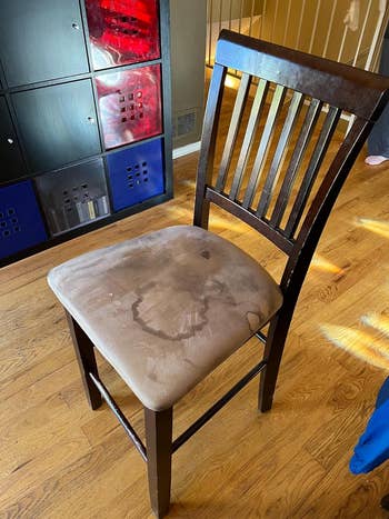 Reviewer's chair with worn, stained cushion