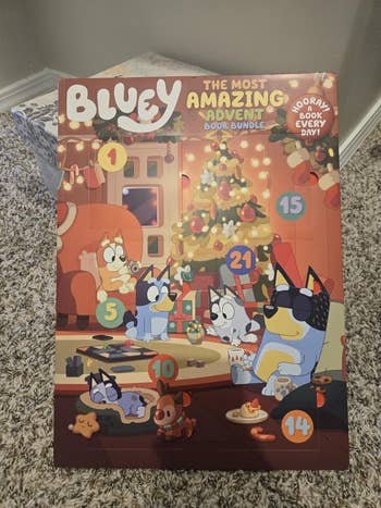 Bluey advent calendar with illustrated household country and numbers. Promotes excitement for regular publication surprises starring up to Christmas