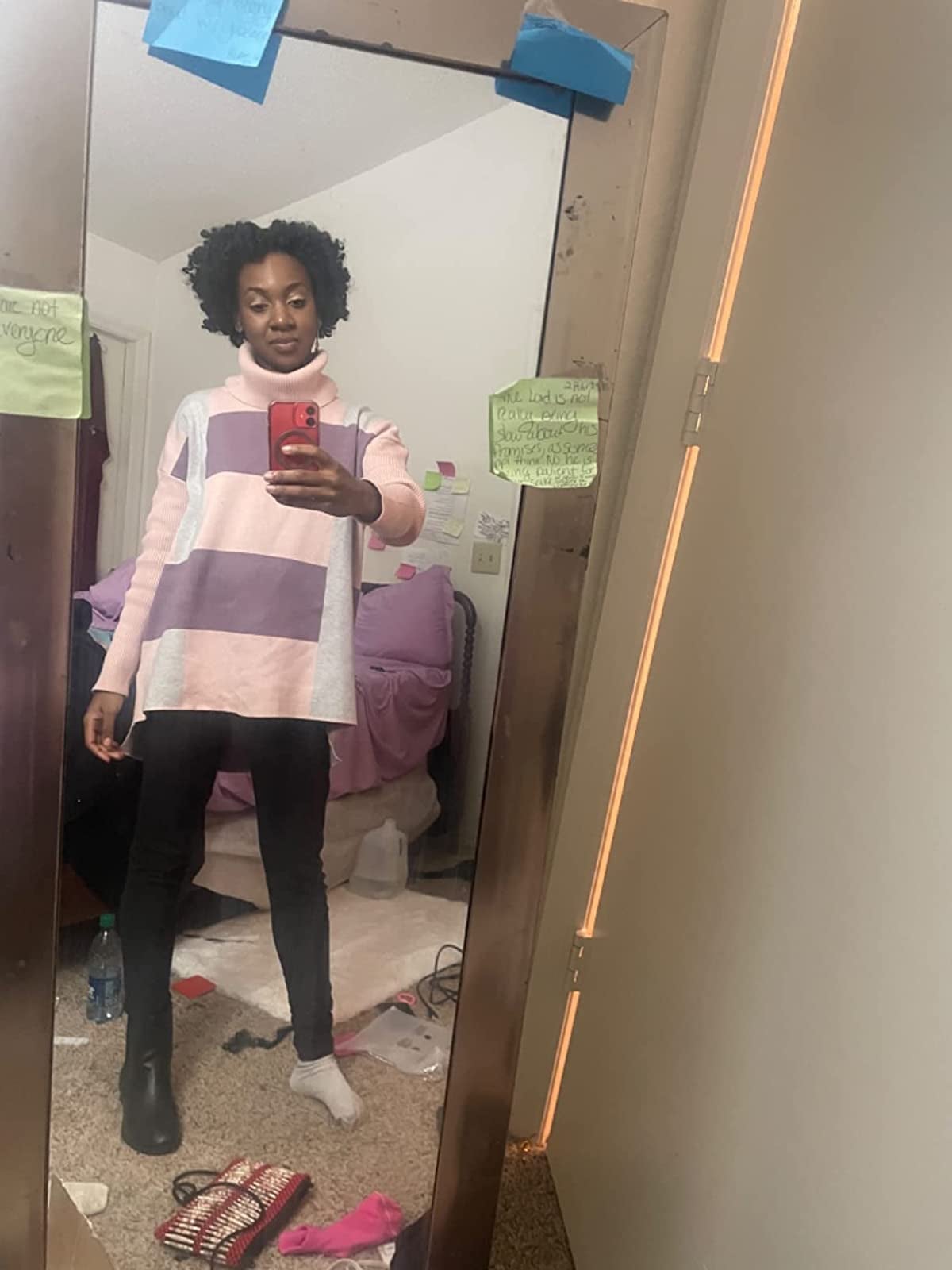 reviewer wearing the pink plaid turtleneck sweater