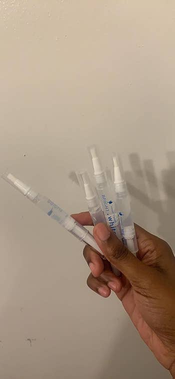 reviewer holding the whitening pens
