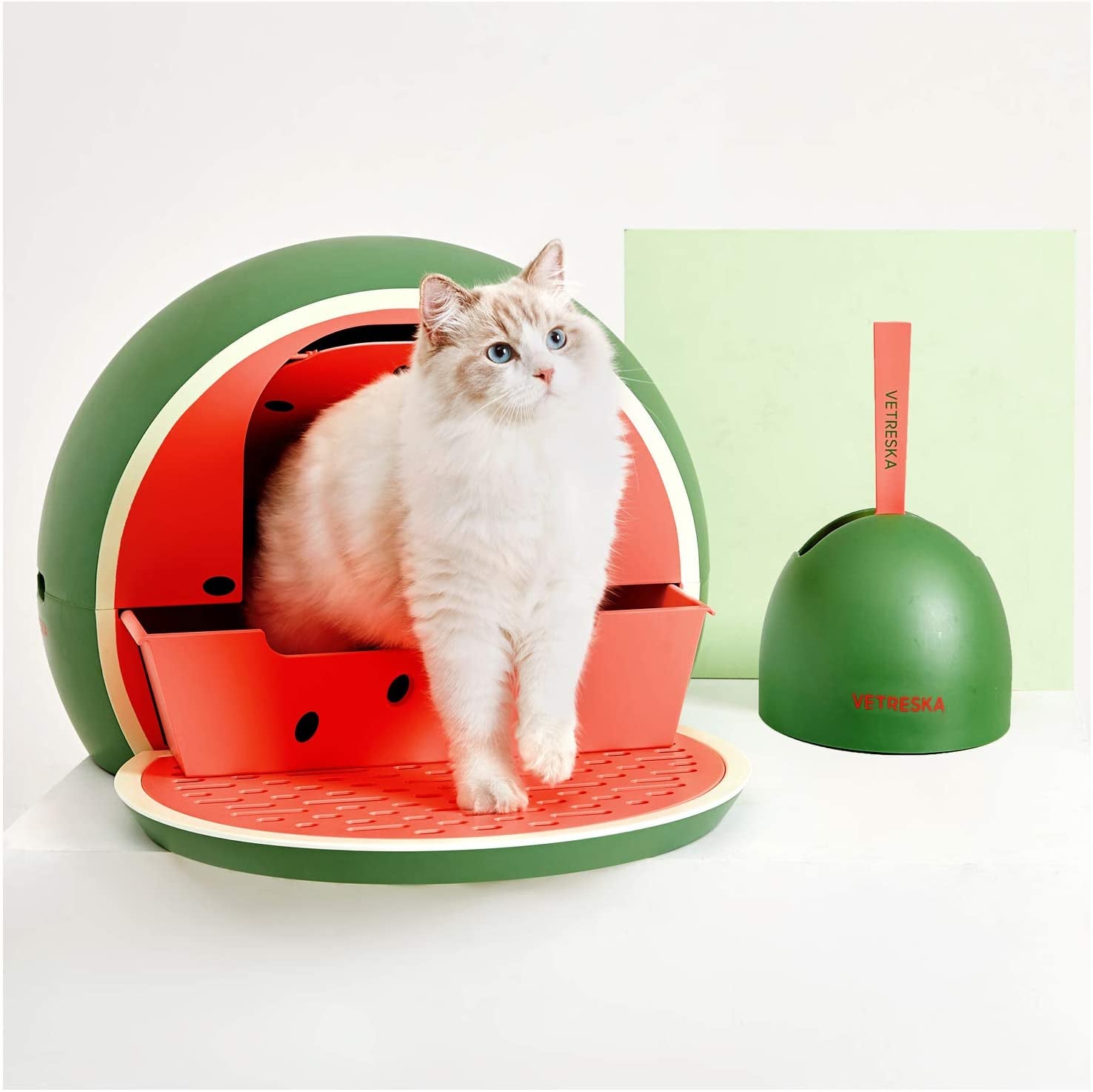 litter box that looks like a watermelon with a matching scoop next to it