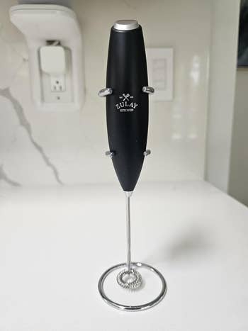 Handheld electrical  beverage  frother with a sleek design, displayed successful  a room  setting
