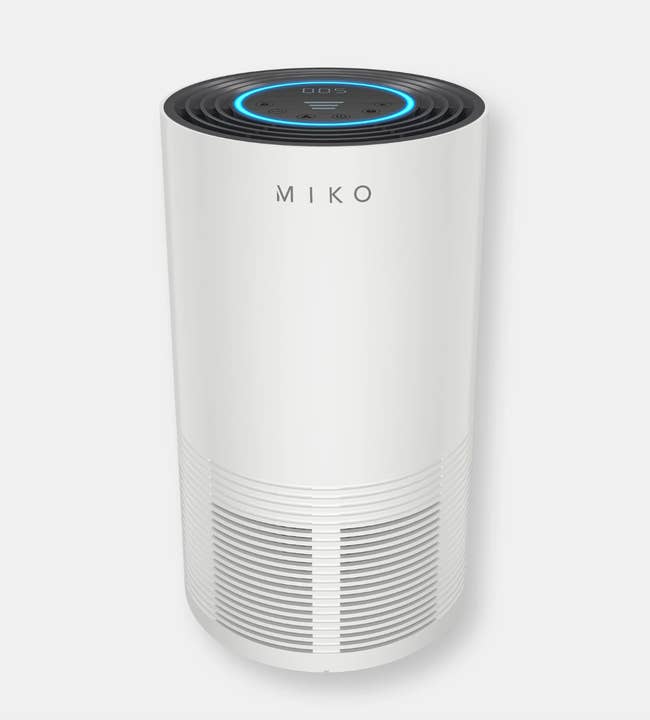 the white miko air purifier with a blue indicator light on