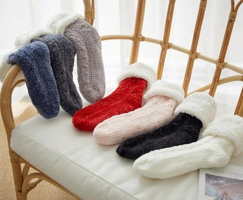 the blue, gray, red, and pink socks laying beside each other on a chair