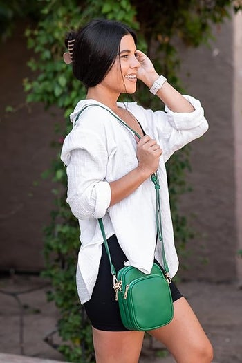 model wearing the green crossbody bag