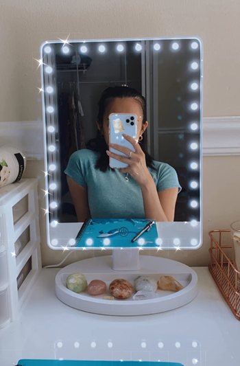 reviewer selfie in lighted mirror