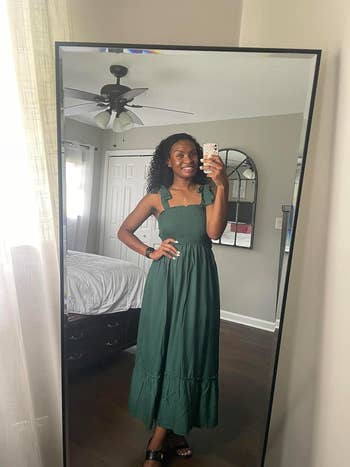 reviewer wearing the dress in green