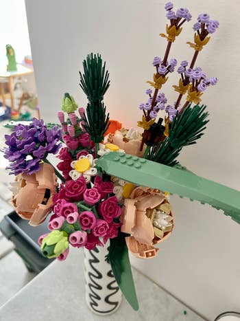 LEGO angiosperm bouquet with assorted intricate floral designs successful a vase, showcasing creativity successful decorative gathering sets for location show and gifts