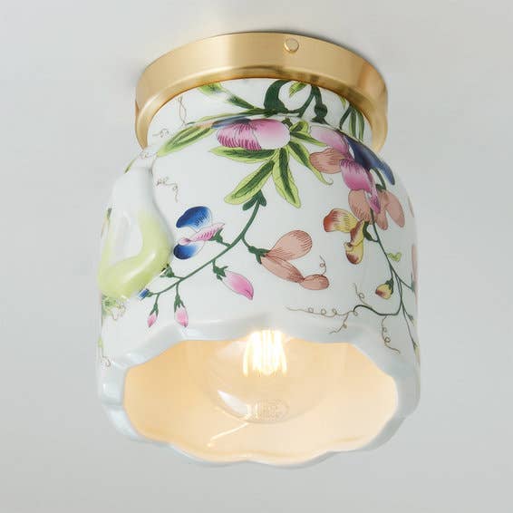 the white ceramic sconce with a floral pattern