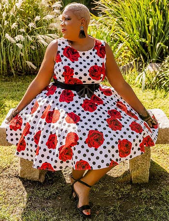 reviewer wearing the white and red rose print dress