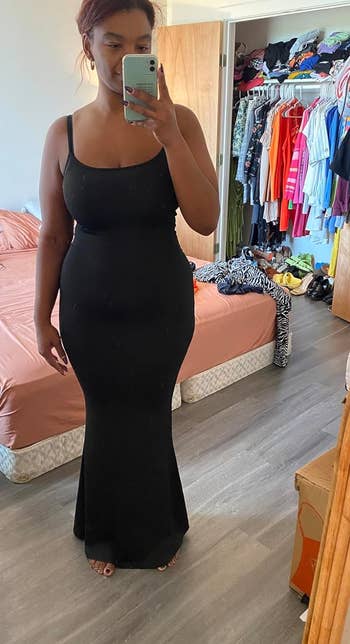 a reviewer wearing the dress in black 