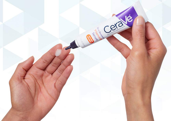 Model applying CeraVe vitamin C serum to finger
