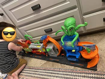 reviewer's photo of their child playing with the car wash toy