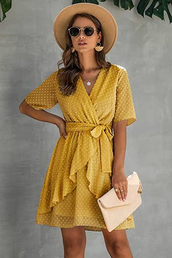 model in short sleeve faux wrap yellow dress