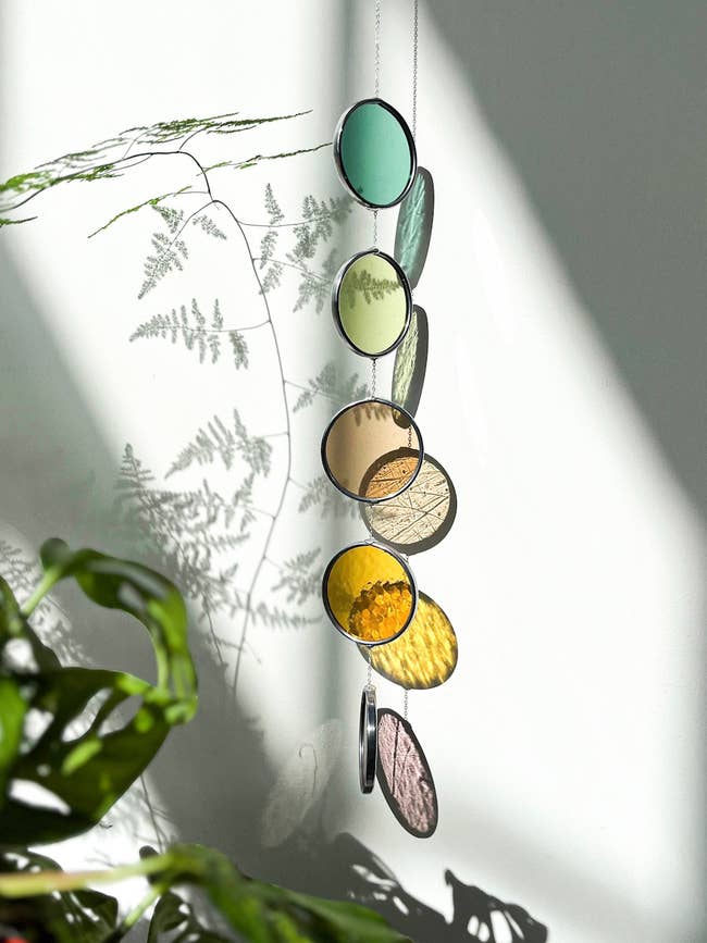 Hanging circular solid suncatchers successful assorted shades make colorful model reflections