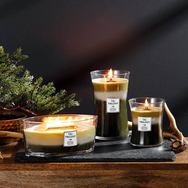 three candles in different sizes all in glass containers