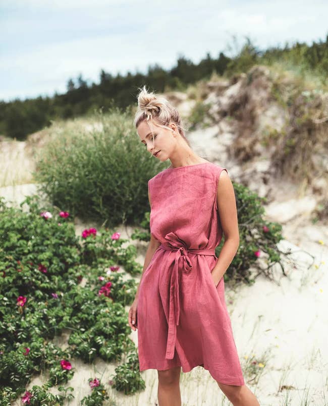 a model in the watermelon colored linen dress