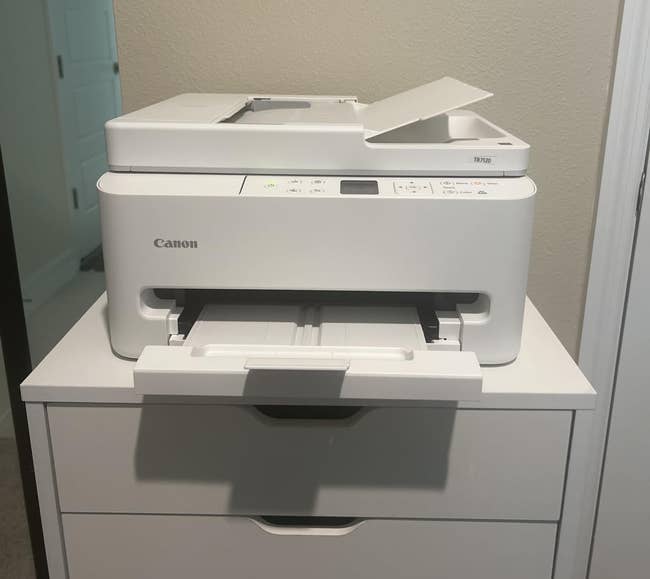 Canon multifunction printer connected a achromatic drawer unit, suitable for location bureau use