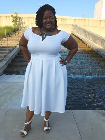 reviewer wearing the cocktail dress in white