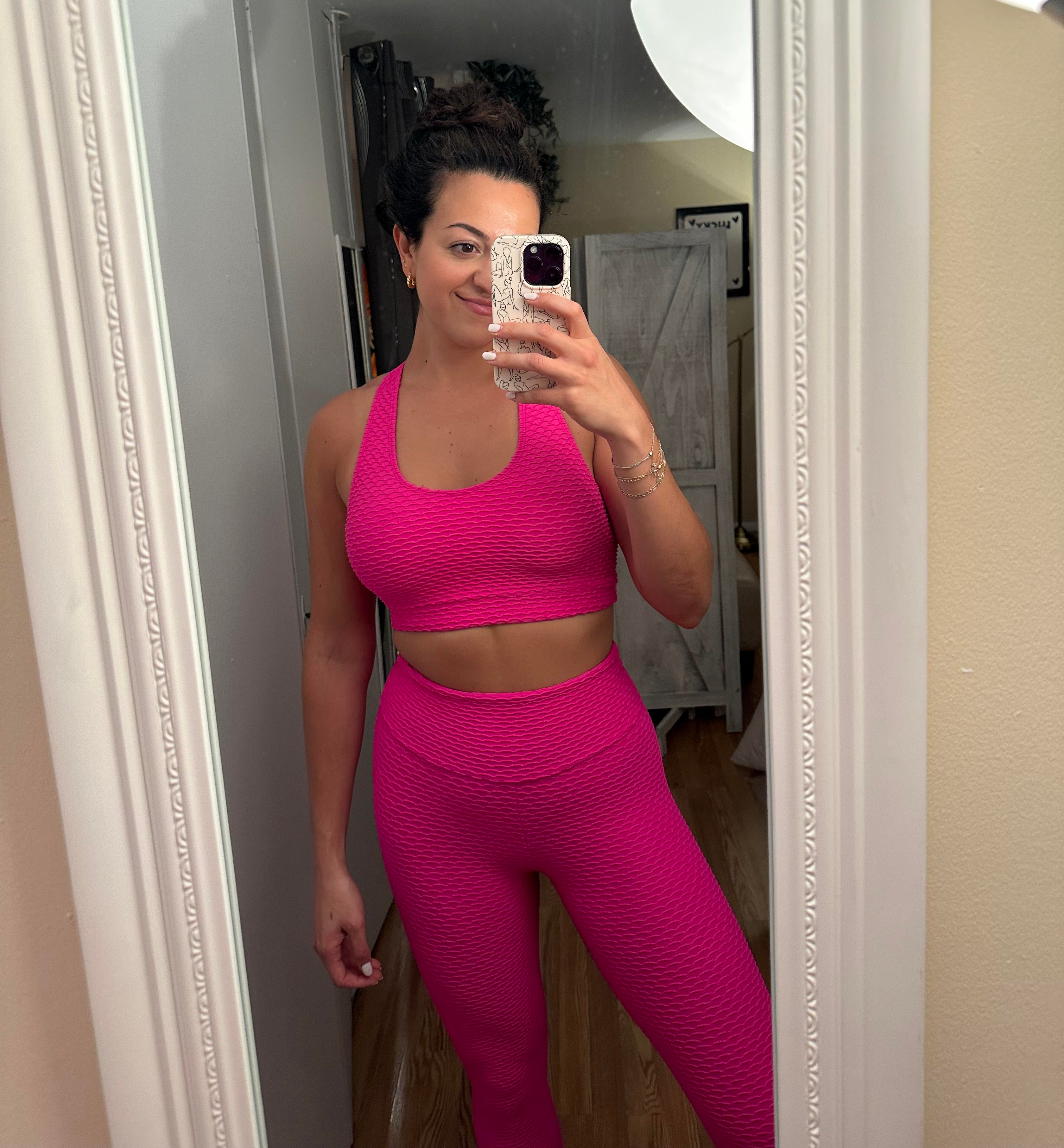 BuzzFeed writer wearing the bright pink sports bra and leggings set