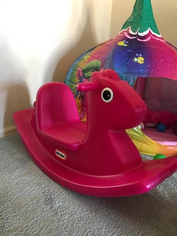 Reviewer's photograph  of magenta rocking horse