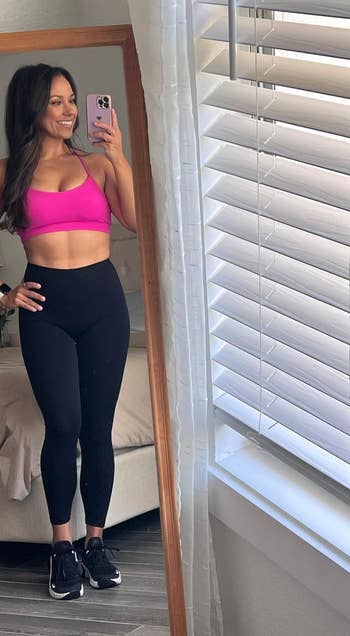 reviewer wearing the pink sports bra