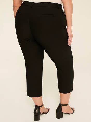 model wearing stylish tailored ankle pants and sandals, viewed from the back