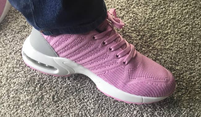 Person wearing a knit sneaker with a heavy   sole