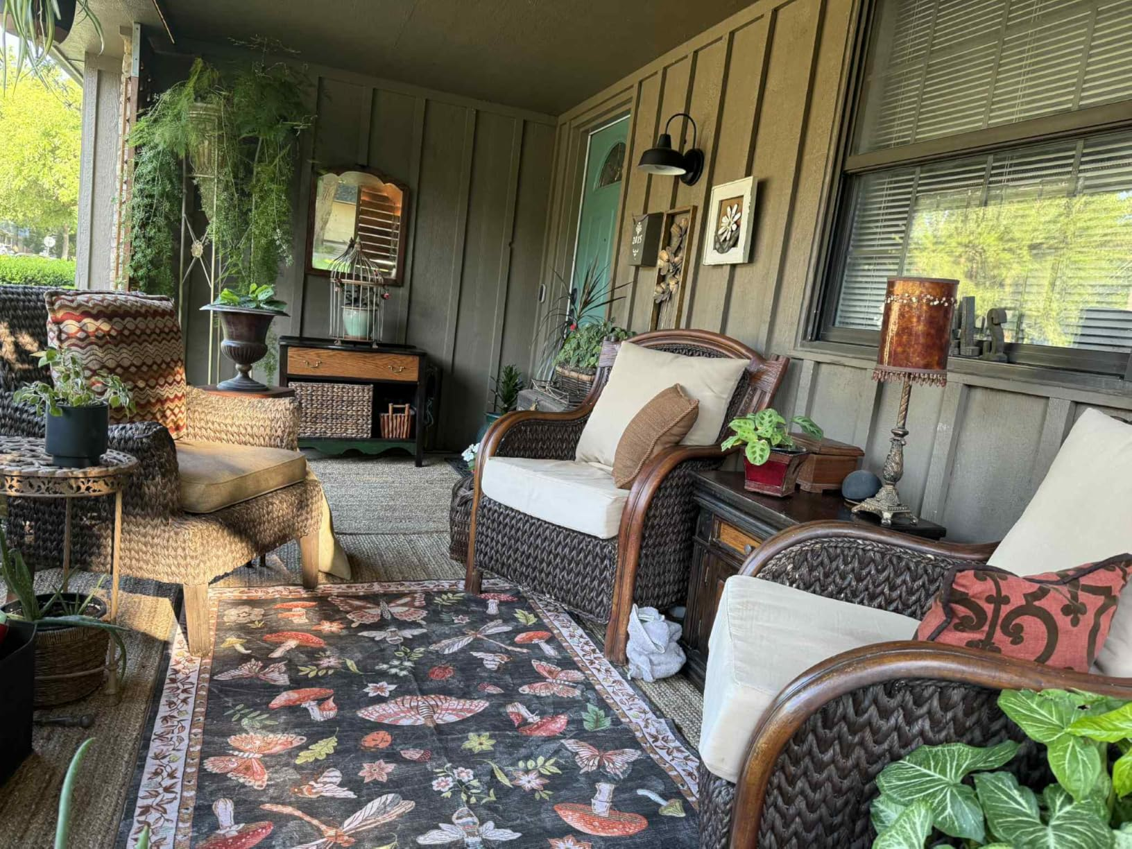Cozy structure  with wicker furniture, patterned rug, plants, and decor items, creating a relaxed outdoor seating area