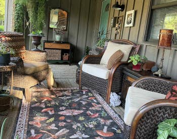 Cozy structure with wicker furniture, patterned rug, plants, and decor items, creating a relaxed outdoor seating area