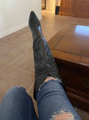 another reviewer showing the embroidery of the black faux leather boots over jeans