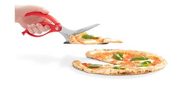 A model using the scissors to pick up a slice of pizza
