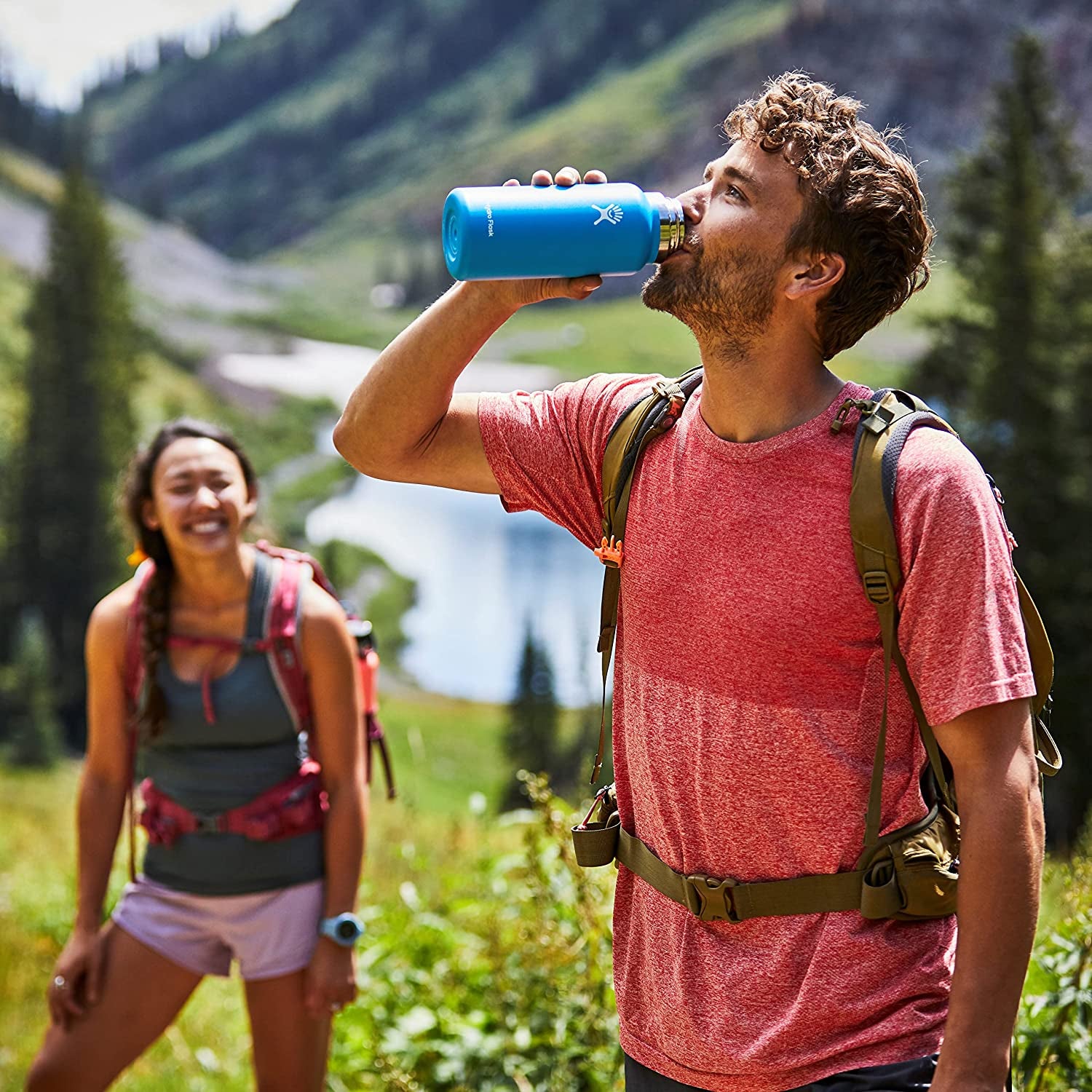 model drinking water from a blue bottle