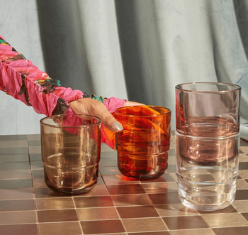 a model stacking four different color glasses