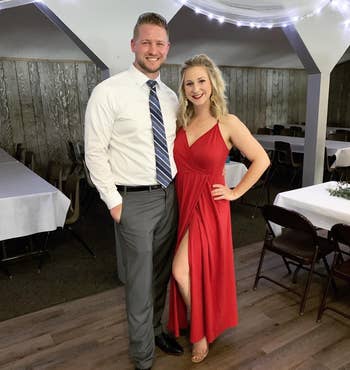 reviewer wearing dress in red, posing with significant other